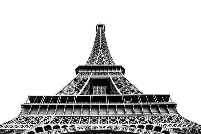 Low angle view of the iconic Eiffel Tower in Paris, captured in monochrome. Ideal for travel blogs, tourism websites, posters, or educational materials about architectural landmarks and French heritage.