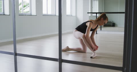 Ballet Dancer Preparing in Modern Dance Studio