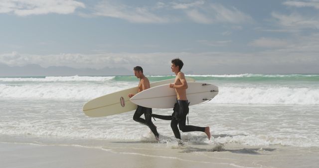 Surfers Running to Ocean with Surfboards on Beach - Download Free Stock Images Pikwizard.com