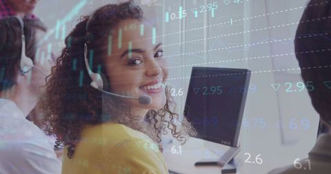 Happy biracial call center worker with financial data overlay