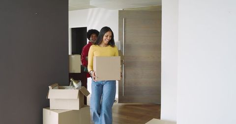 Couple relocating to new home with packing boxes