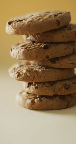 Vertical Stack of Delicious Chocolate Chip Cookies on Yellow Background - Download Free Stock Images Pikwizard.com