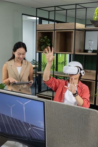 Using vr to interact with renewable energy model while colleague reviews data on tablet