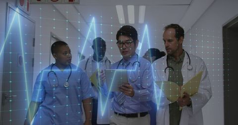 Diverse Medical Team Analyzing Data in Hospital Corridor