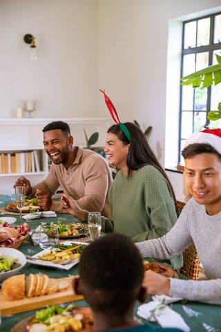 Diverse Group Enjoying Festive Meal Together in Bright Room
