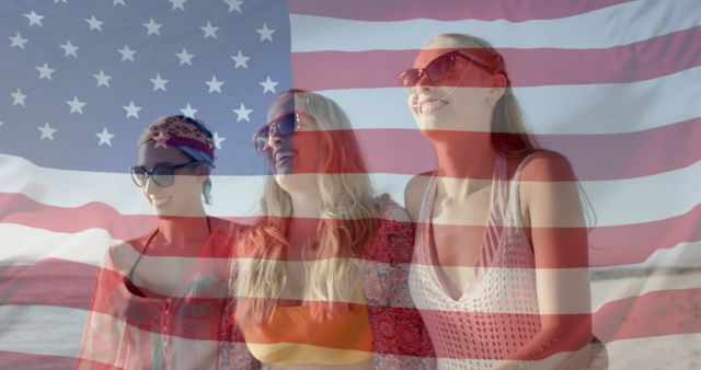 Group of women walking and enjoying time together on a sunny beach, with the American flag superimposed in the background. Perfect for content related to patriotism, summer activities, vacations at the beach, girls’ trips, and beach lifestyles. Suitable for advertisements, promotional materials, and social media posts focusing on warm weather wear and national pride.