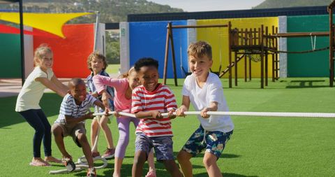 Joyful Multiracial Kids Engaging in Tug of War Outdoors - Download Free Stock Images Pikwizard.com