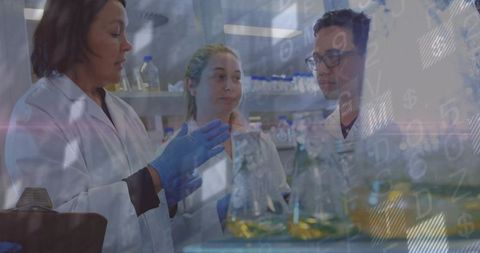 Scientist Guiding Colleagues in Chemistry Laboratory