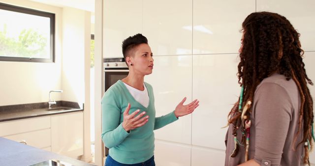 Two Women Having a Serious Conversation in Modern Kitchen - Download Free Stock Images Pikwizard.com