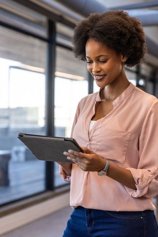Confident Businesswoman Engages in Work Standing in Modern Office Corrdor