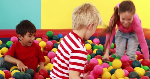 Joyful Children Playing in Colorful Ball Pit at Playschool