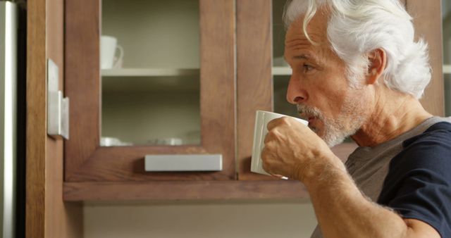 Senior Man Enjoying Coffee in Contemporary Kitchen - Download Free Stock Images Pikwizard.com