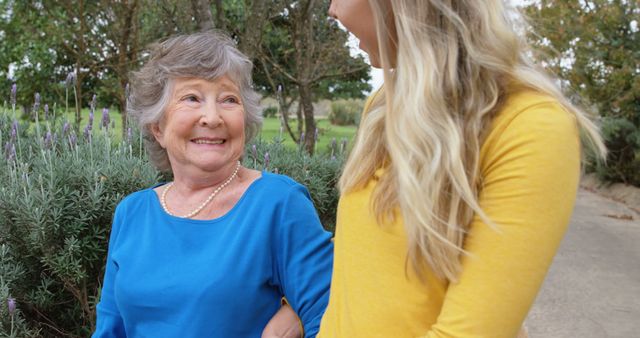 Smiling Elderly Woman Enjoying Outdoor Walk with Caregiver - Download Free Stock Photos Pikwizard.com