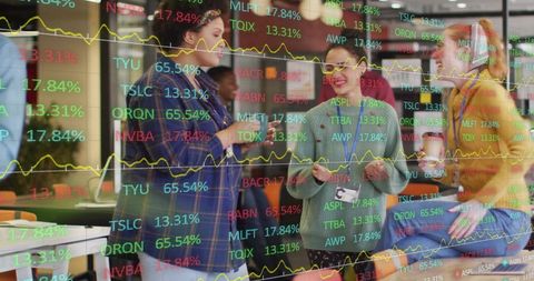 Diverse Women Engaging in Office with Stock Market Data Overlay