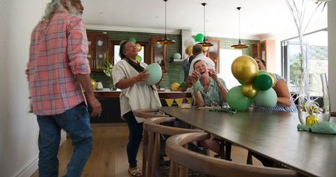 Seniors Decorating for Festive Party with Joyful Laughter