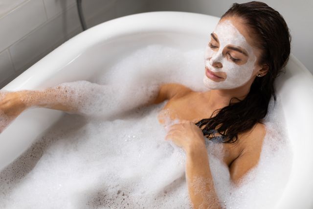 Woman Relaxing in Bathtub with Foam and Facemask - Download Free Stock Photos Pikwizard.com
