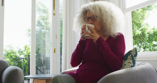 Senior Woman Relaxing at Home Drinking Coffee by Window - Download Free Stock Images Pikwizard.com