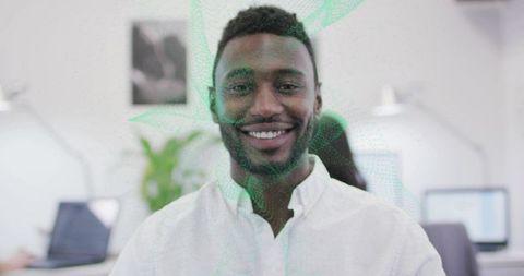 Smiling man in open-plan office creates welcoming atmosphere