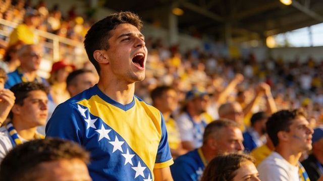 Young fan shouting in blue yellow jersey with diagonal stars cheering in stadium