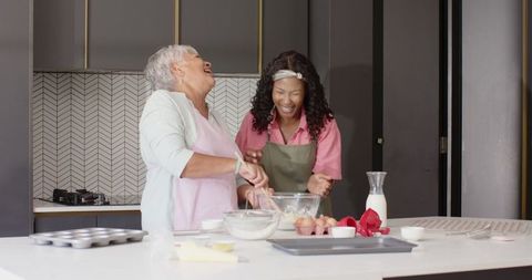 Grandmother and Granddaughter Baking Together Sharing Joyful Moments
