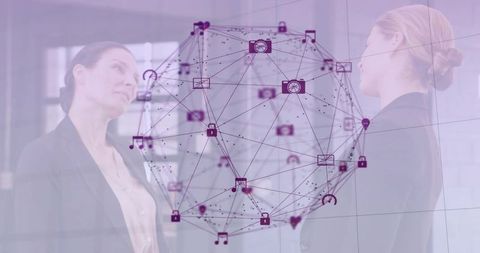 Businesswomen Viewing Holographic Network Globe Showing App Icons and Data Connectivity