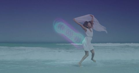 Woman Dancing on Beach with Neon Magic in Breeze