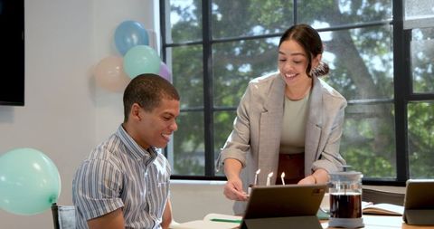 Coworkers Celebrate Birthday With Cake in Decorated Office