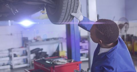 Mechanic Examining Car Tire in Auto Repair Shop - Download Free Stock Images Pikwizard.com