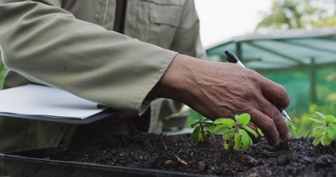 Gardener taking notes in speaking garden center