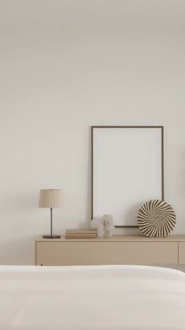 Vertical video tilting from bed revealing minimalist dresser with lamp frame and decor