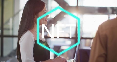 Asian woman discussing nfts with colleague in modern office