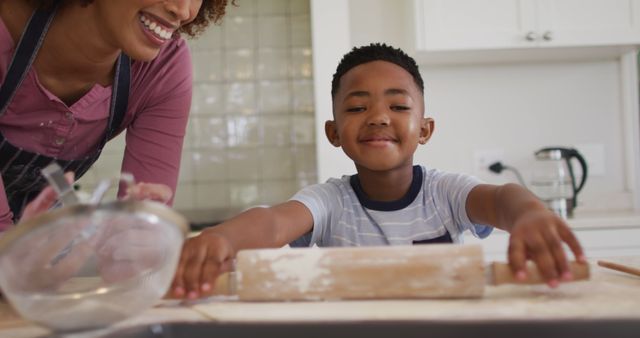 African american mother and son baking together in the kitchen at home. family, love and togetherness concept