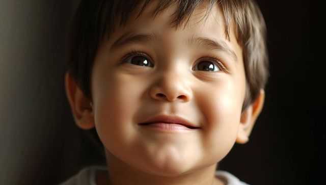 Toddler smiling and gazing upward with soft curious eyes close-up portrait warm light