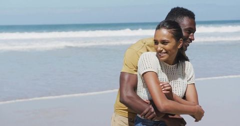 Romantic Couple Embracing on Sunlit Beach Scenic