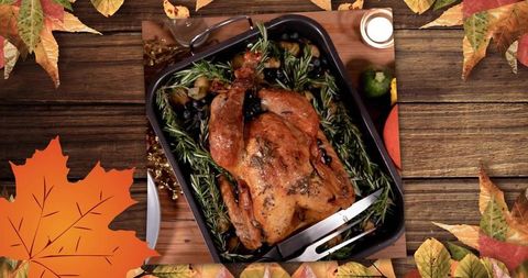 Golden whole roast poultry on rosemary bed in rustic roasting pan for autumn feast