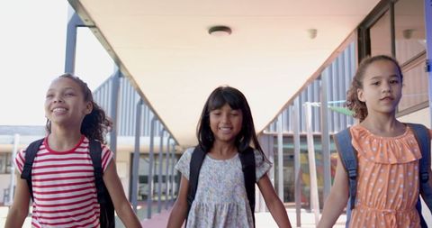 Joyful School Kids Walking Together with Backpacks in Sunshine - Download Free Stock Images Pikwizard.com