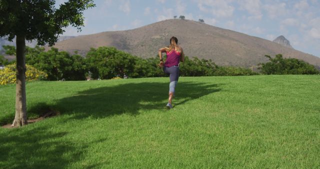 Woman Jogging on Grassy Field Surrounded by Nature - Download Free Stock Images Pikwizard.com