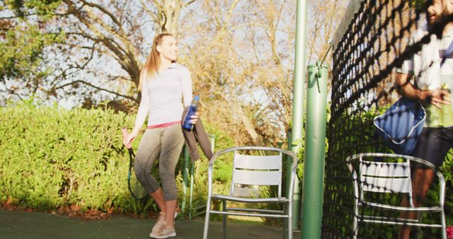 Woman and Man Socializing at Tennis Court after Game - Download Free Stock Images Pikwizard.com