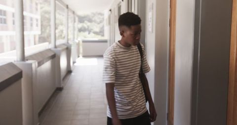 Teenage Boy Walking in Hallway Reflecting on Student Life - Download Free Stock Images Pikwizard.com