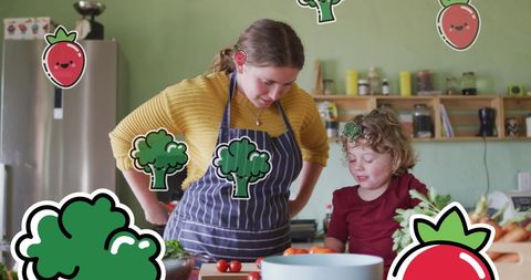 Mother and Son Enjoying Cooking Together with Fun Vegetables Icons Overlay