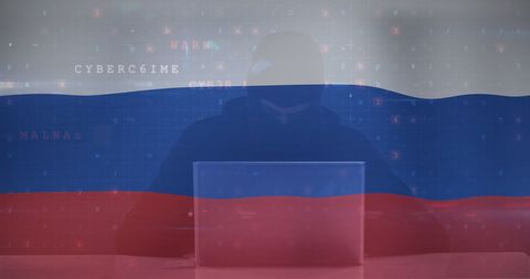 Hacker in silhouette with russian flag highlighting cyber threats