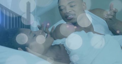 Couple Relaxing and Laughing Together in Cozy Bedroom