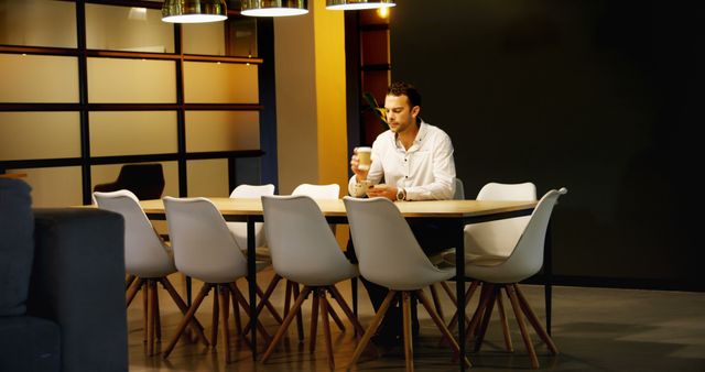 Businessman Drinking Coffee in Modern Office Setting - Download Free Stock Images Pikwizard.com