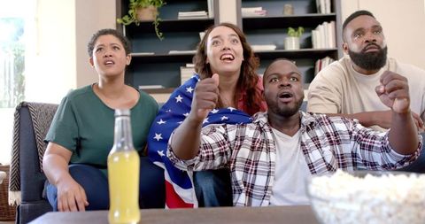 Diverse Group of Friends Celebrating Sports Game at Home