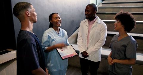 Diverse medical team celebrating achievement with award