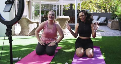 Diverse Friends Filming Outdoor Yoga on Patio