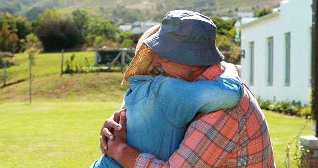 Two middle-aged Caucasian individuals are embracing in a comforting hug outdoors, with copy space. Their affectionate gesture conveys a sense of support and closeness in a serene rural setting.