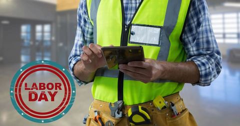 Construction worker using tablet with labor day concept