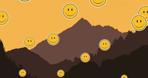 Smiley emojis floating over majestic mountain silhouette