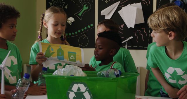 Happy diverse pupils learning about recycling in elementary school ecology class. Ecology, recycling, environmental awareness, childhood, education, learning and elementary school, unaltered.